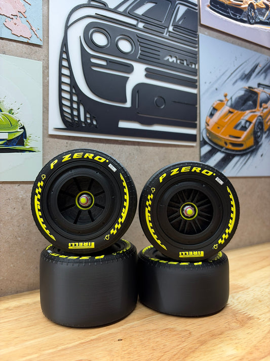 2026 Ferrari F1-style 3D-printed black racing wheels for 1:8 scale models, featuring yellow P Zero tyre markings, black spoke designs and detailed centre-lock hubs.